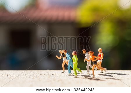 Miniature People : Group Of People Are Running  On Concrete Road