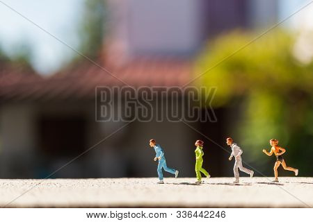 Miniature People : Group Of People Are Running  On Concrete Road