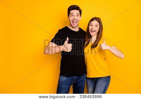 Photo Of Positive Cheerful Cute Charming Girlfriend And Boyfriend Showing Their Thumbs Up Wearing Je