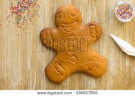 Baked Gingerbread Cookie Man Before Decoration On Wooden Background