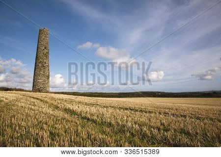 A Chimney From A Ruined Tin Mine Stands In A Field In Cornwall, Uk