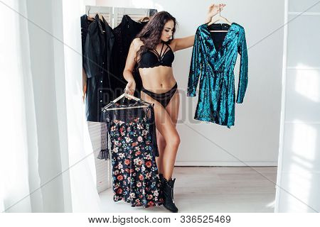 Beautiful Woman In Lingerie Different Clothes In The Wardrobe