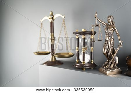Judge And Justice Concept. Themis Statue, Scale And Hourglass On Off-white Background.