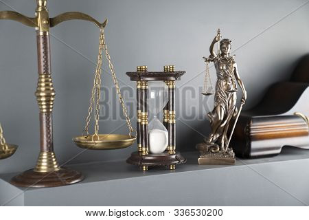 Judge And Justice Concept. Themis Statue, Scale And Hourglass On Off-white Background.