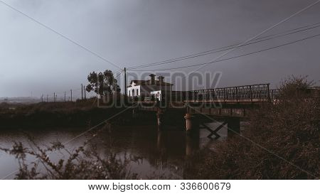 A Mysterious Morning Foggy Scenery With An Old Rusty Bridge And A Small River In The Middle, Dry Bus