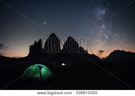 Our Galaxy Is On The Sky. Two Lighting Tents With Tourists Inside Near The Tre Cime Three Peaks Moun