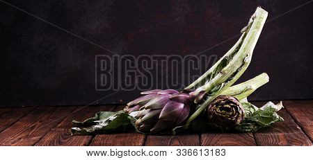 Artichokes On Rustic Background. Fresh Raw Organic Artichoke Flower.