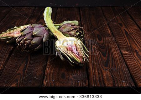Artichokes On Rustic Background. Fresh Raw Organic Artichoke Flower.