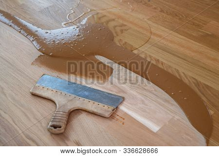 Mix Of Wood Dust, Wood Varnish, Hardener And Other Parquet Varnishes, Spatula On The Floor