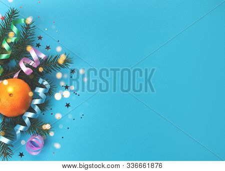 Christmas Decoration With Bottle Of Champagne And Branches Of Spruce On Blue Background.