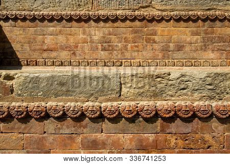 Graceful Ancient Stone Carving. Brown Stone Texture. Wall Of An Old Hindu Temple At Durbar Square In