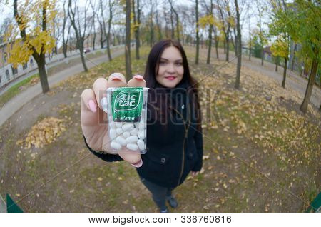 Kharkov, Ukraine - October 26, 2019: Young Woman Shows New Tic Tac Hard Mints Package In Autumn Park