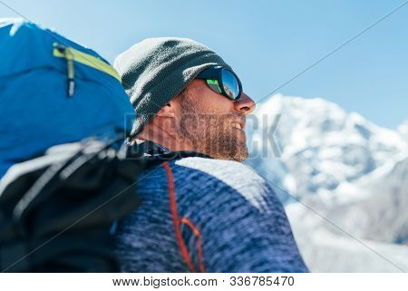 Portrait Of Unshaved Hiker Man With Backpack And Uv Protecting Sunglasses On Taboche 6495m Peakk Bac