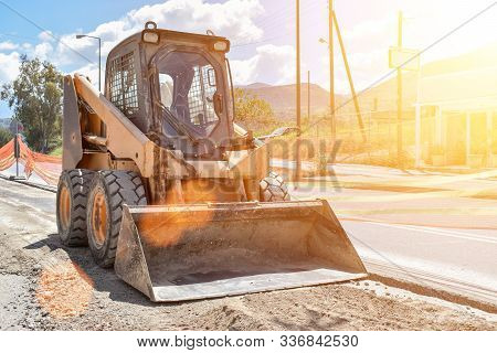 Small Bulldozer Does The Work On The Street.