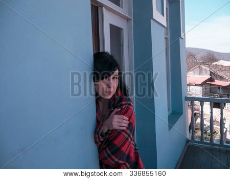 Woman On Balcony With Coffee At Home