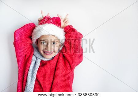 7 Yaers Old Smiling Girl With Changing Tees Smiling In Santa Hat, Red Pullover, Gray Scarf, Imitatio