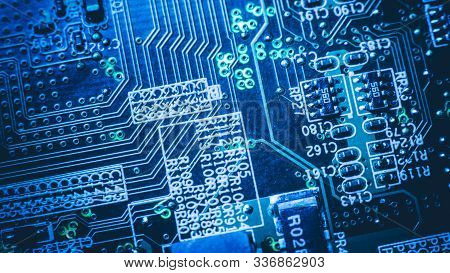 Microelectronics Engineering. Printed Circuit Board. Blue Glowing Conductive Tracks Pads.
