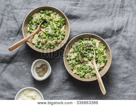 Green Peas, Spring Herbs Orzotto On A Gray Background, Top View. Vegetarian Food Concept