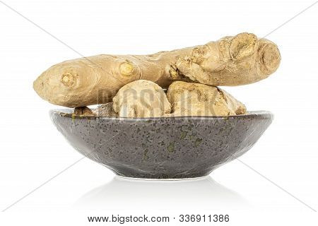 Group Of Three Whole Fresh Brown Ginger In Glazed Bowl Isolated On White Background