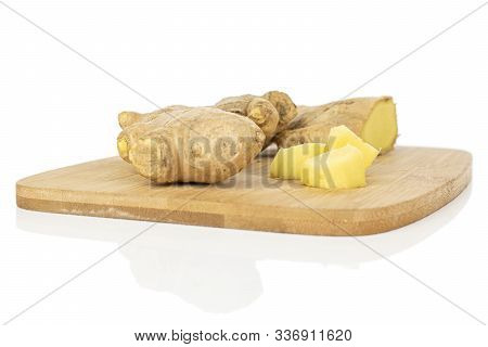Group Of Two Whole Four Pieces Of Fresh Brown Ginger On Bamboo Cutting Board Isolated On White Backg