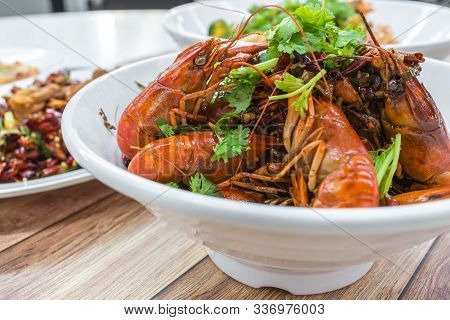 China, Chongqing Sichuan Spicy Dried Chilli Small Lobsters, Among Other Dishes In The Background. Fo