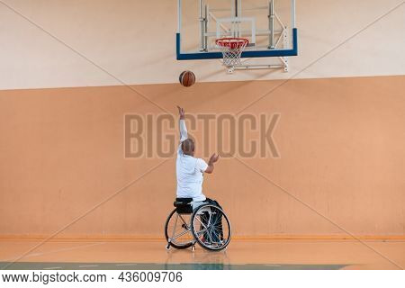 a photo of a war veteran playing basketball in a modern sports arena. The concept of sport for people with disabilities