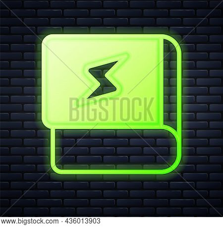 Glowing Neon Book About Electricity Icon Isolated On Brick Wall Background. Vector