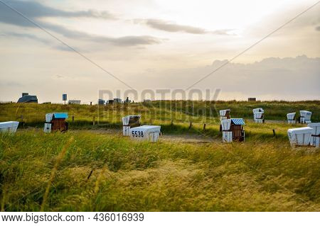 Traditional German Roofed Wicker Beach Chairs On The Beach Of North Sea, Nordsee, Germany, Wattenbee