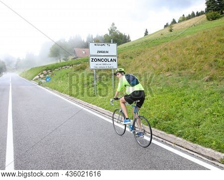 Young Cyclist Climbs The Tiring Steep Climb Of Mount Zoncolan In Italy During A Rainy Day