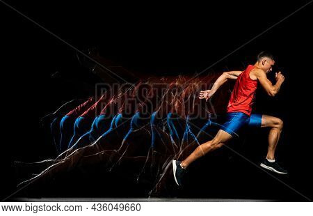 Full-length Portrait Of Young Male Athlete, Professional Runner In Motion Isolated Over Black Backgr