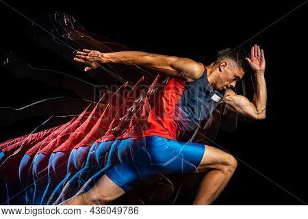 Cropped Portrait Of Young Athletic Man, Professional Runner Isolated Over Black Background. Strobosc