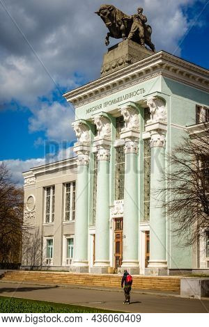 Moscow, Russia, April 23, 2016: A roller-blader moves past the Meat Industry Pavilion at the Exhibition of Achievements of National Economy in Moscow, Russia