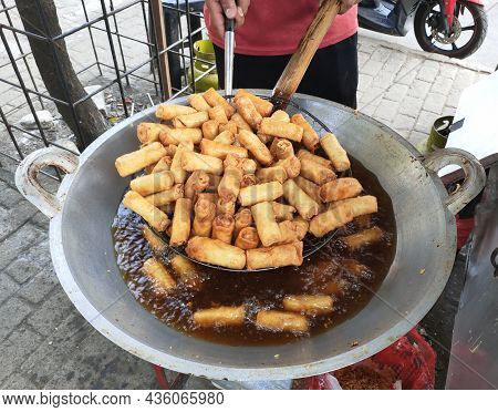 Jakarta, Indonesi-october 10, 2021: Close-up Of Hands Frying Risol In A Large Skillet