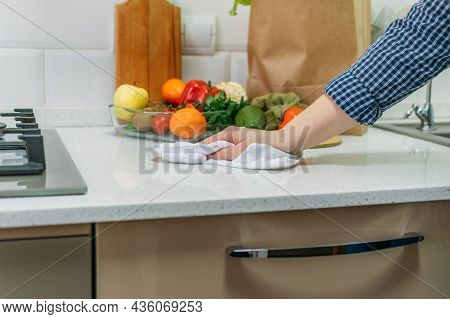 Female Hand With A Rag Cleaning Kitchen Desk. Microfiber Cloth, Absorbent Towels, Reuseable Cloth Fo