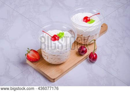 Dessert Creme Brulee In Glasses On A Blackboard On A Marble Background