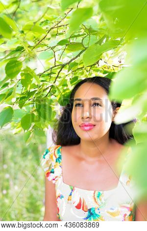 Beautiful Bright Portrait Of A Mixed Race African American Woman Standing Under A Tree With Bright G