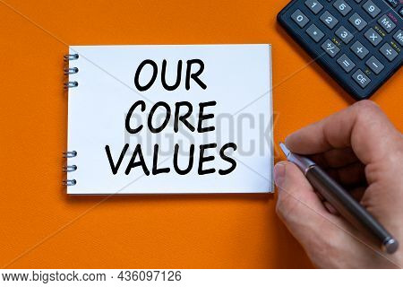 Our Core Values Symbol. Businessman Writing Words 'our Core Values' On White Note. Black Calculator.