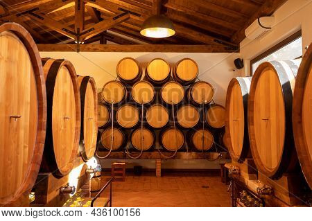 White, Rose And Red Wine In Barrels For Sale In Wine Cellars In Italy