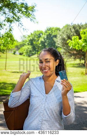 A Smiling Mixed Race African American Woman In A Blue Collared Shirt Holds Up A Blue Plastic Credit 