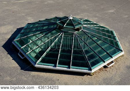 Polygonal Window At Ground Level In The Shape Of A Hexagonal Pyramid With Ventilation In The Shape O