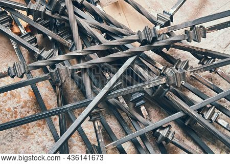 Large Pile Of Elegant Forged Metal Balusters Lies On Floor Before Applying Paint In Light Handycraft