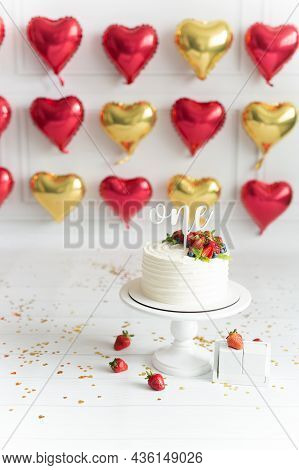 Festive Location With The First Birthday Cake White Background With Yellow Sparkles In The Form Of A