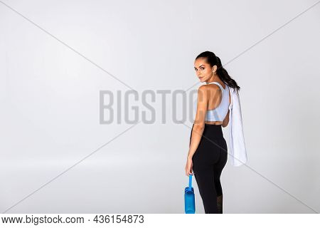 Fitness Woman Ready For Exercise In Sportswear Stainding On White Background With Towel, Trainer Rel