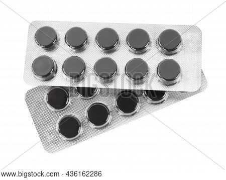 Activated Charcoal Pills In Blisters On White Background, Top View. Potent Sorbent
