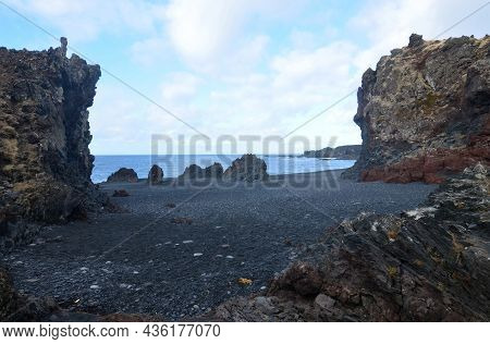 Icelandic Black Lava Rock Cliffs On Black Sand Beach.