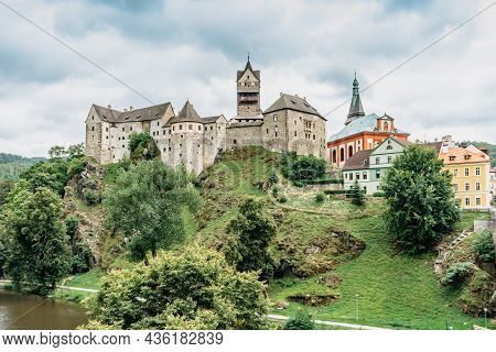 Panoramic View Of Famous Medieval Town Of Loket,elbogen, With Colorful Houses And Stone Castle Above