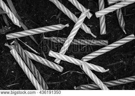 A Macro Close Up Black And White Photograph Of A Bunch Of Spiral Wax Birthday Candles Spilled And Sc