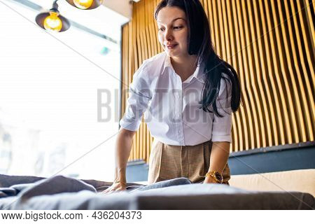 Indian Woman Setting The Table For Dining In Day Light Room