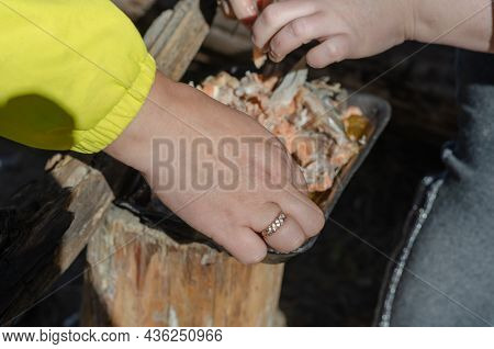 Two Women Are Going Over Pieces Of Cooked Fish With Their Hands. They Are Removing The Fish Bones. S