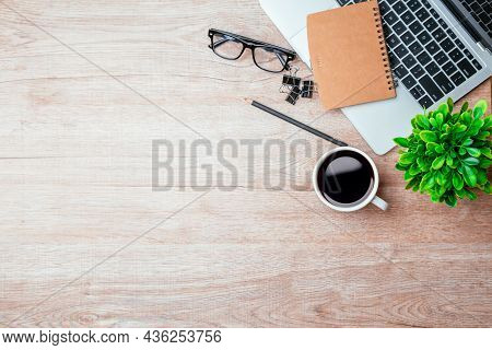 Work From Home. Desk Office With Laptop, Blank Notepad, Coffee Cup And Pen On Wood Table. Flat Lay T